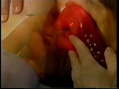 Sexy little whore wraps her lips around two hard cocks